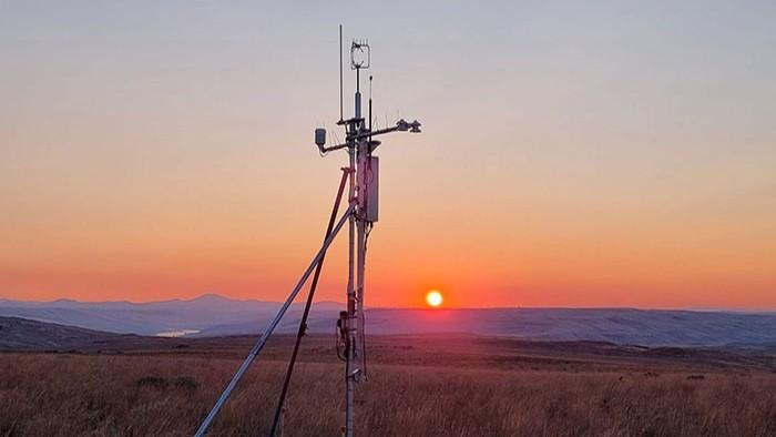 Ecosystem monitoring device with sunset in the background.