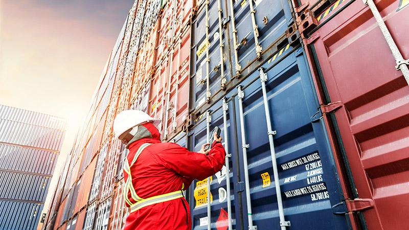 Foreman in front of containers