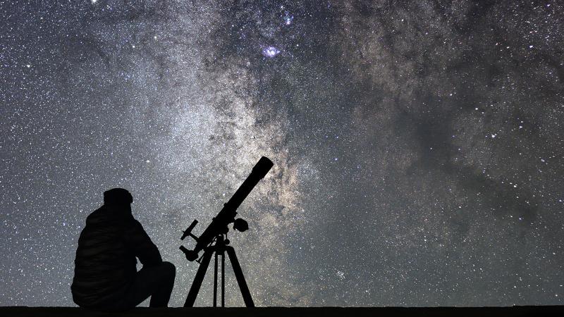 Man with telescope watching space