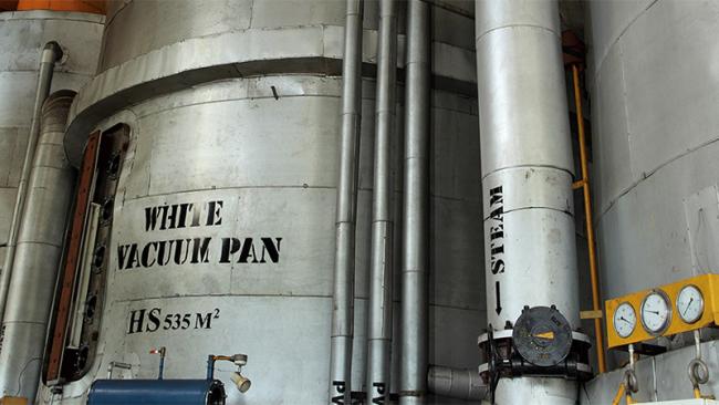 Vacuum pan processing equipment in a modern sugar mill factory