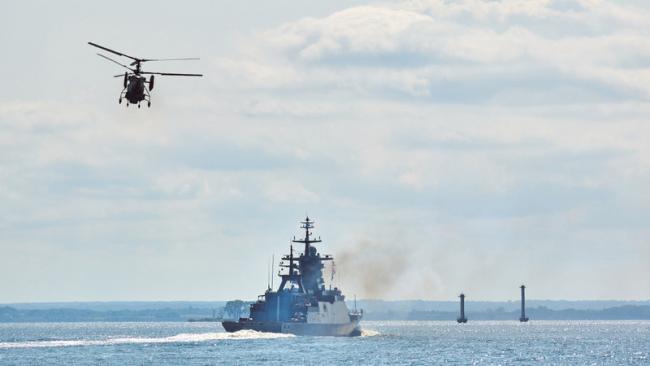 Military vessel and helicopter at sea.