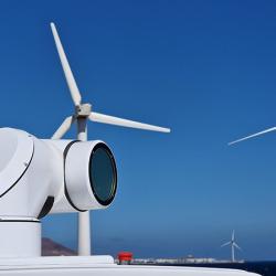 WindCube closeup with wind turbines in the back.